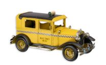 A TIN MODEL OF A YELLOW CAB
