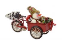 A TIN MODEL OF A CARGO BIKE IN CHRISTMAS STYLE