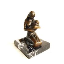 A BRONZE SCULPTURE OF A MOTHER AND CHILD
