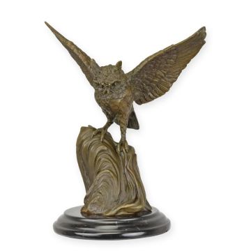 A BRONZE SCULPTURE OF AN OWL WITH WINGS WIDE