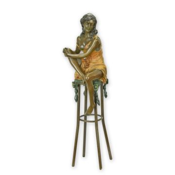 A BRONZE SCULPTURE OF A LADY ON BARCHAIR