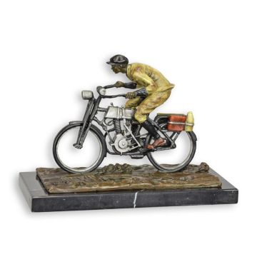 A BRONZE SCULPTURE OF A MAN ON A BIKE