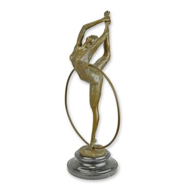 A BRONZE SCULPTURE OF A HOOP DANCER