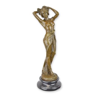 A BRONZE SCULPTURE OF A WOMAN PLAYING WITH HER HAIR