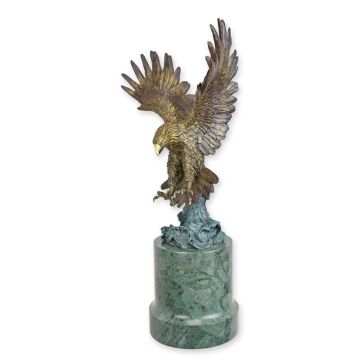 A BRONZE SCULPTURE OF A FLYING EAGLE
