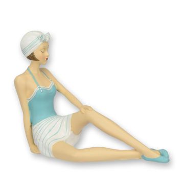 A RESIN FIGURINE OF A RETRO BEACH GIRL