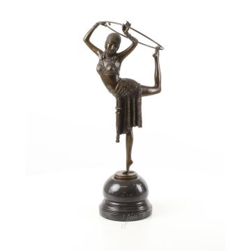 A BRONZE SCULPTURE OF A HOOP DANCER
