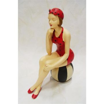 A RESIN FIGURINE OF A LADY IN SWIMSUIT