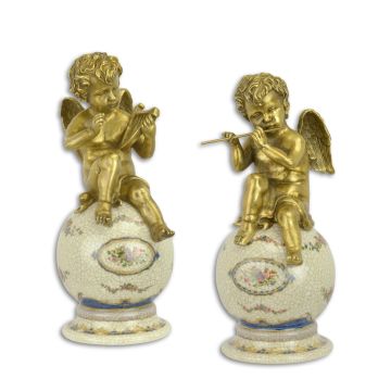 A PAIR OF BRONZE PUTTI ON PORCELAIN BALL