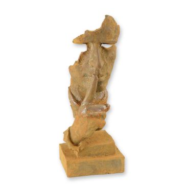 A RUSTY CAST IRON STATUE OF A WHISPERING FACE