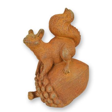 A RUSTY CAST IRON FIGURINE OF A SQUIRREL ON AN ACORN