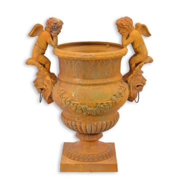 A RUSTY CAST IRON GARDEN URN