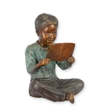 A BRONZE SCULPTURE OF A BOY READING
