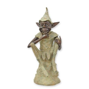A BRONZE SCULPTURE OF A GOBLIN SITTING ON A ROCK