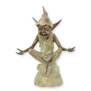 A BRONZE SCULPTURE OF A GOBLIN SITTING ON A ROCK