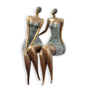 A BRONZE SCULPTURE OF TWO WOMAN SITTING MODEL
