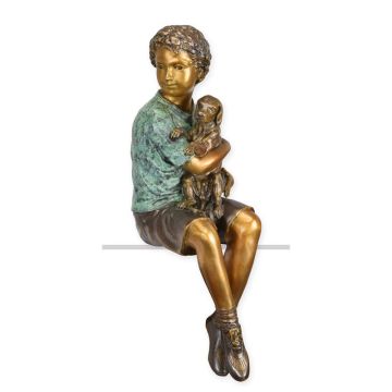 A BRONZE SCULPTURE OF A BOY HOLDING HIS DOG