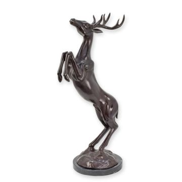 A BRONZE SCULPTURE OF A JUMPING DEER ON A MARBLE BASE