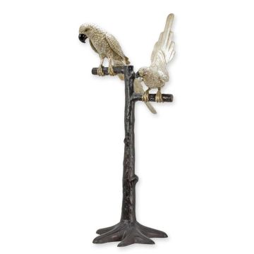 A BRONZE SCULPTURE OF 2 PARROTS SITTING IN A TREE
