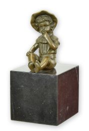 A BRONZE SCULPTURE OF A LITTLE GIRL SITTING
