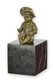A BRONZE SCULPTURE OF A LITTLE BOY SITTING