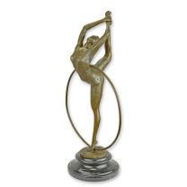 A BRONZE SCULPTURE OF A HOOP DANCER