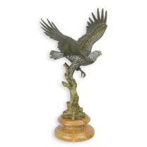 A BRONZE SCULPTURE OF AN EAGLE IN A FLIGHT
