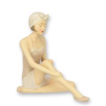 A RESIN FIGURINE OF A RETRO BEACH GIRL