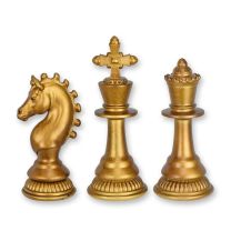 A SET OF 3 RESIN CHESS PIECES - OLD GOLD