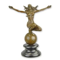 A BRONZE SCULPTURE OF A WOMAN ON TOP OF THE WORLD