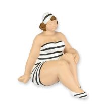 A RESIN FIGURINE OF A WOMAN IN SWIMSUIT