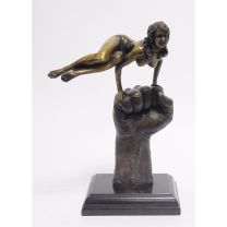 A BRONZE SCULPTURE OF A SWIRLING NUDE ON A HAND