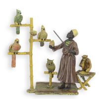 A BRONZE SCULPTURE OF A PARROT TRAINER