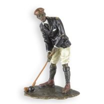 A BRONZE SCULPTURE OF A GOLFER