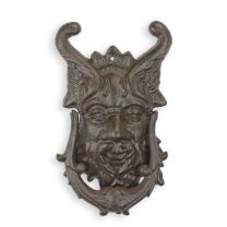 A CAST IRON DEVIL FACE DOOR KNOCKER