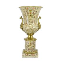 A BRONZE MOUNTED URN ON BASE