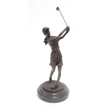 A BRONZE SCULPTURE OF A LADY GOLFER