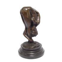 A BRONZE SCULPTURE OF A CONTORTIONIST