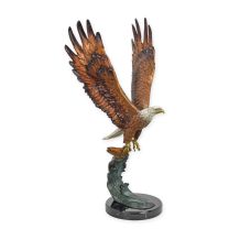 A BROZNE SCULPTURE OF AN EAGLE CATCHING A FISH