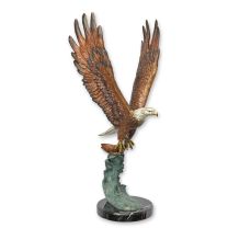 A BRONZE SCULPTURE OF AN EAGLE IN FLIGHT