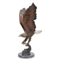A BRONZE SCULPTURE OF AN EAGLE FISHING FOR SALMON