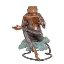 A BRONZE SCULPTURE OF A READING FROG