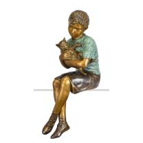 A BRONZE SCULPTURE OF A GIRL HOLDING HER CAT