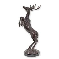A BRONZE SCULPTURE OF A JUMPING DEER ON A MARBLE BASE
