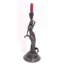 A FIGURAL BRONZE CANDLESTICK