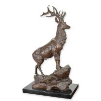 A BRONZE SCULPTURE OF A STAG ON ROCK