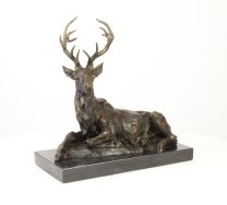 A BRONZE SCULPTURE OF A RECLINING DEER